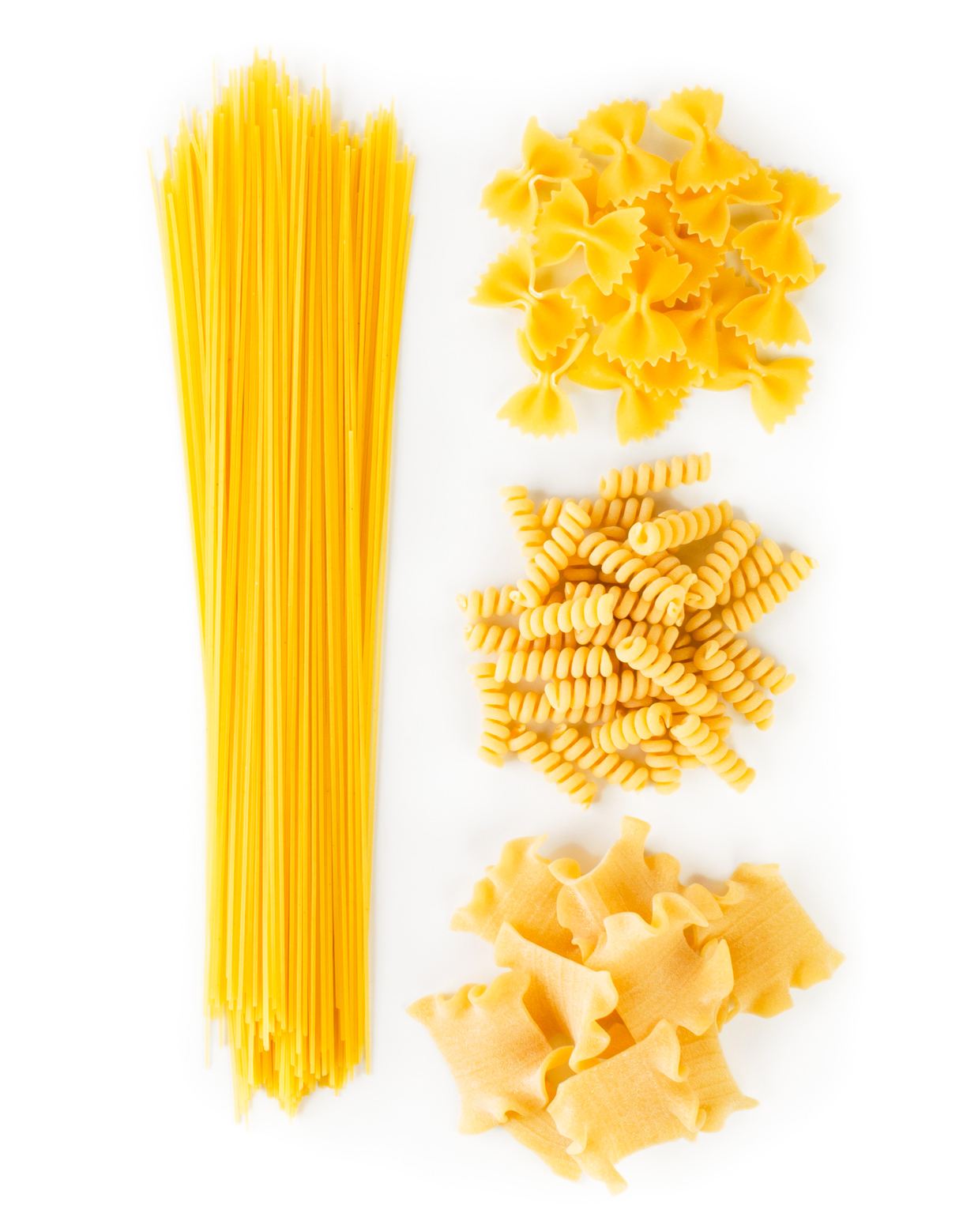 A set of spaghetti and pasta on a white. The view from the top